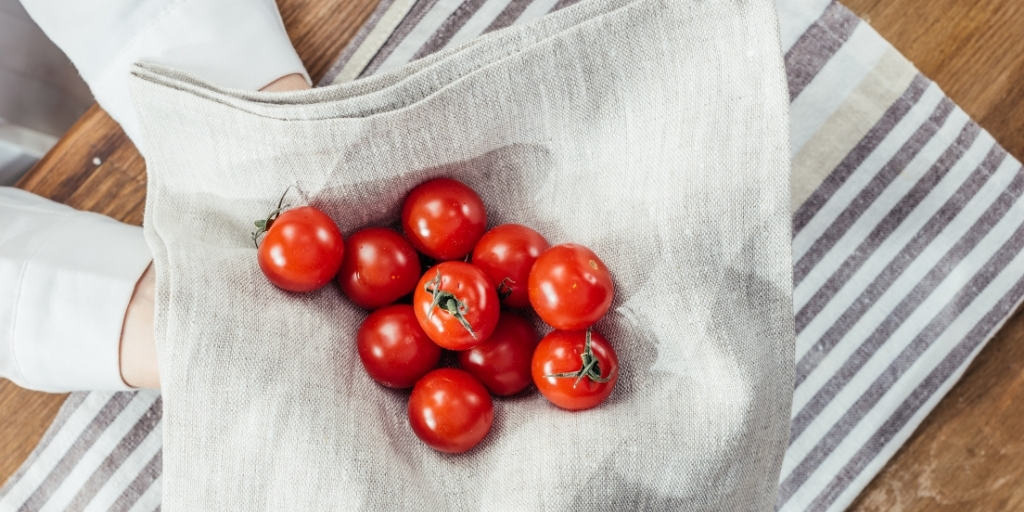 cherry tomatoes in a napkin ready to be sliced by the best tomato knife