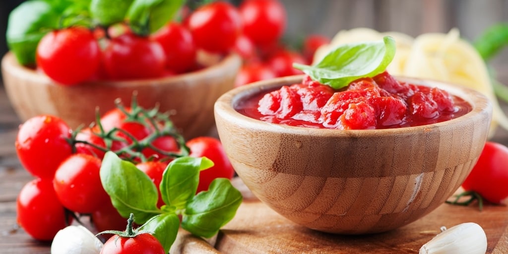 homemade tomato sauce in a wooden bowl made using the best tomato knife