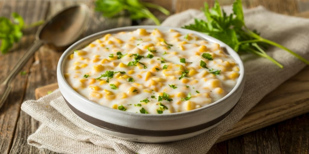 what to serve with chicken and dumplings side dish creamed corn in bowl on table with dish cloth
