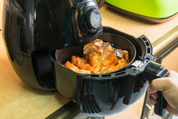 close up of a personal sized air fryer with fries in it